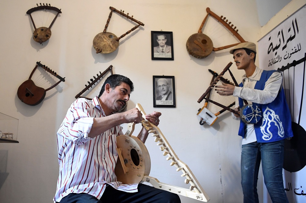 Egyptian craftsman Mohamed Ghaly adds the finishing touches on a semsemia fan that he made at the Canal 20 cultural museum in the northeastern city of Port Said at the northern terminus of the Suez Canal May 29, 2019. u00e2u20acu201d AFP pic     