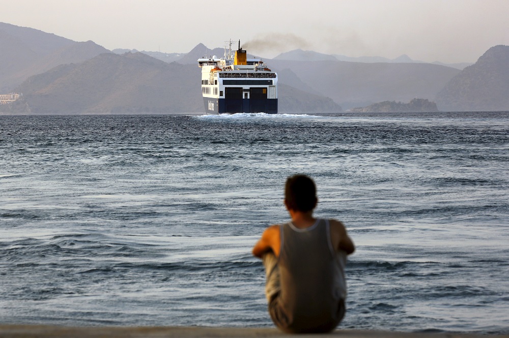 A Bangladeshi migrant, pending temporary documentation, watches from the port of Kos, Greece, a ferry bound for the port of Piraeus near Athens August 10, 2015. u00e2u20acu201d Reuters pic        