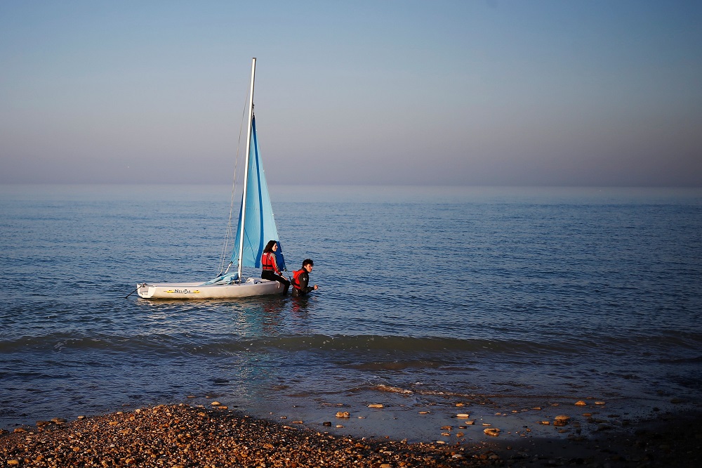 People sail along the English Channel at dusk in Lion-sur-Mer, northwestern France February 27, 2019. u00e2u20acu201d AFP pic        