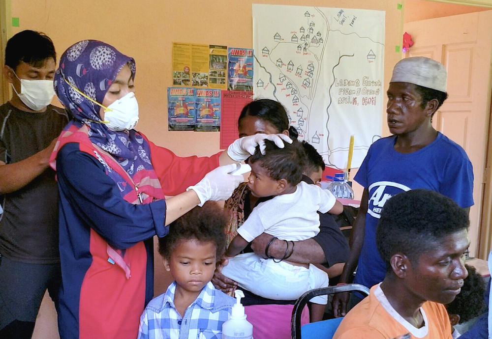 Members of the Batek tribe in Kampung Kuala Koh and Kampung Aring 5 are checked before their measles vaccinations in Gua Musang July 2, 2019. u00e2u20acu201d Bernama pic
