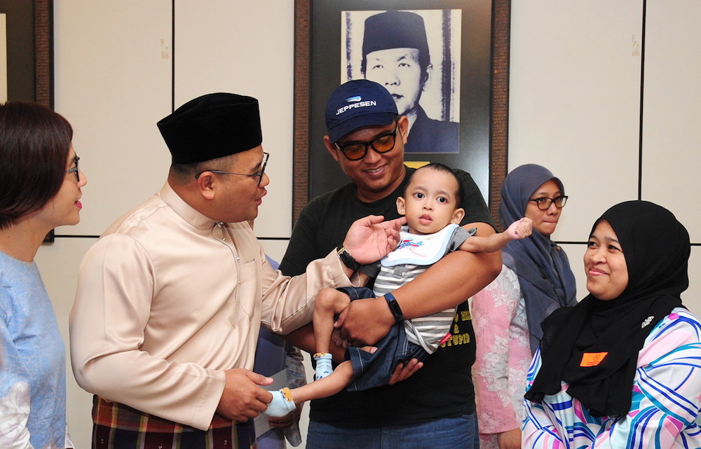 Selangor Mentri Besar Amirudin Shari interacts with a special needs child during an appreciation ceremony in Shah Alam July 19, 2019. u00e2u20acu201d Bernama pic