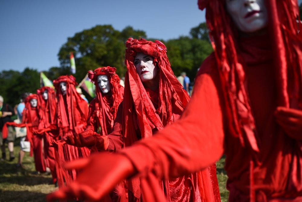 Protestors from climate change group Extinction Rebellion walk through Glastonbury Festival of Music and Performing Arts on Worthy Farm near the village of Pilton in Somerset, South West England June 27, 2019. u00e2u20acu201d AFP pic          