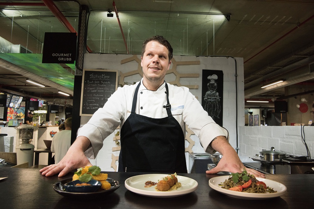 Mario Barnard, chef at Gourmet Grubb, works at his food stand specialising in using insects in cuisine in Cape Town July 17, 2019. — AFP pic      