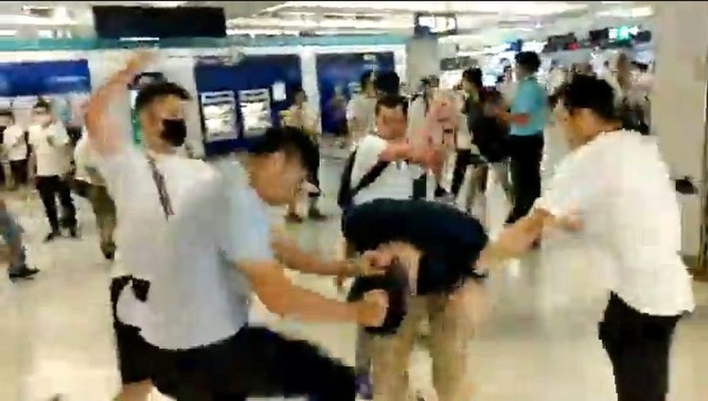 Men in white t-shirts and face masks attack anti-extradition bill demonstrators and reporters at a train station in Hong Kong, July 21, 2019, in this still image obtained from a social media live video. u00e2u20acu201d Courtesy of Stand News/Social Media via Reuters