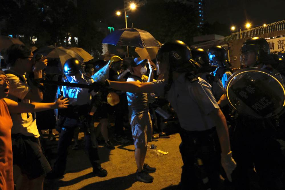 Police officers shout towards anti-extradition Bill protesters who surrounded a police station where detained protesters are being held during clashes in Hong Kong July 30, 2019. u00e2u20acu2022 Reuters pic