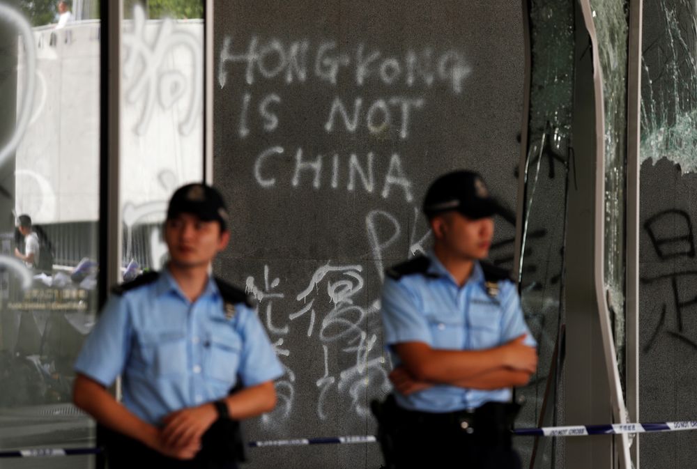 Policemen stand in front of graffiti on the walls of the Legislative Council, a day after protesters broke into the building in Hong Kong, China July 2, 2019. u00e2u20acu201d Reuters pic