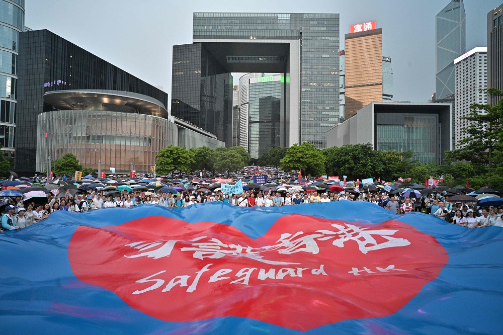People wave a large banner that reads u00e2u20acu02dcsafeguard Hong Kongu00e2u20acu2122 during a pro-government rally outside the government headquarters in Hong Kong July 20, 2019. u00e2u20acu201d AFP pic                     