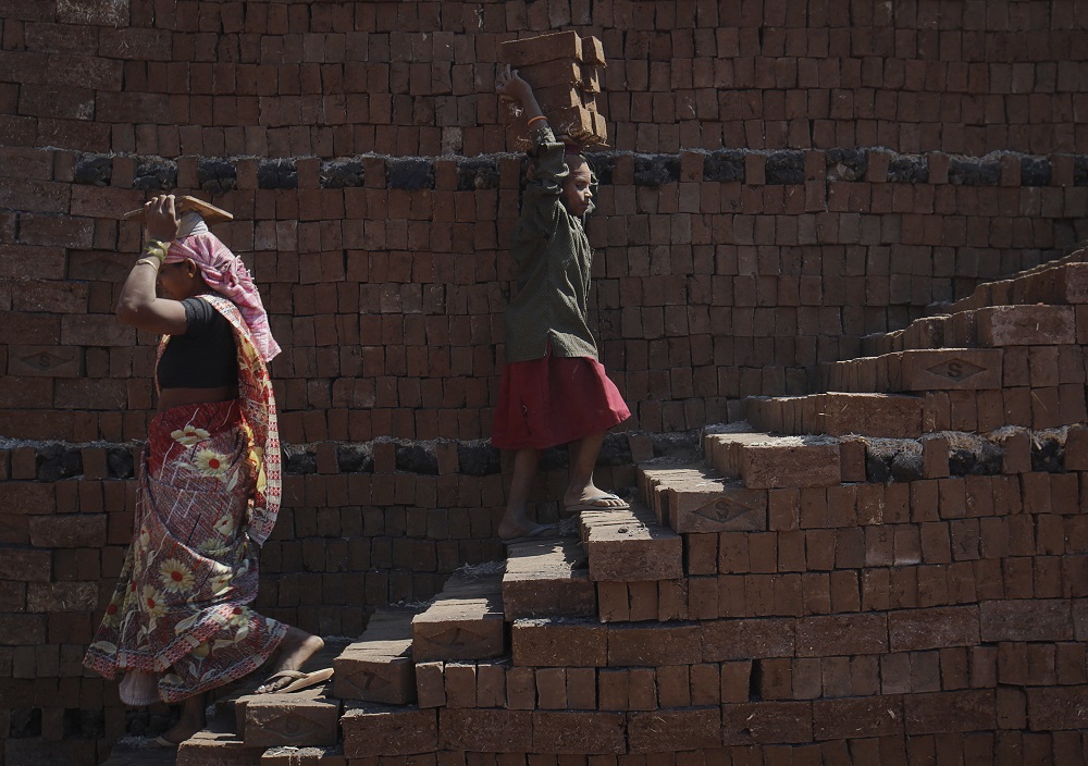 A girl carries bricks to be baked in a kiln at a brickyard on the outskirts of Karad in Satara district, about 396km south of Mumbai February 13, 2012. u00e2u20acu201d Reuters pic