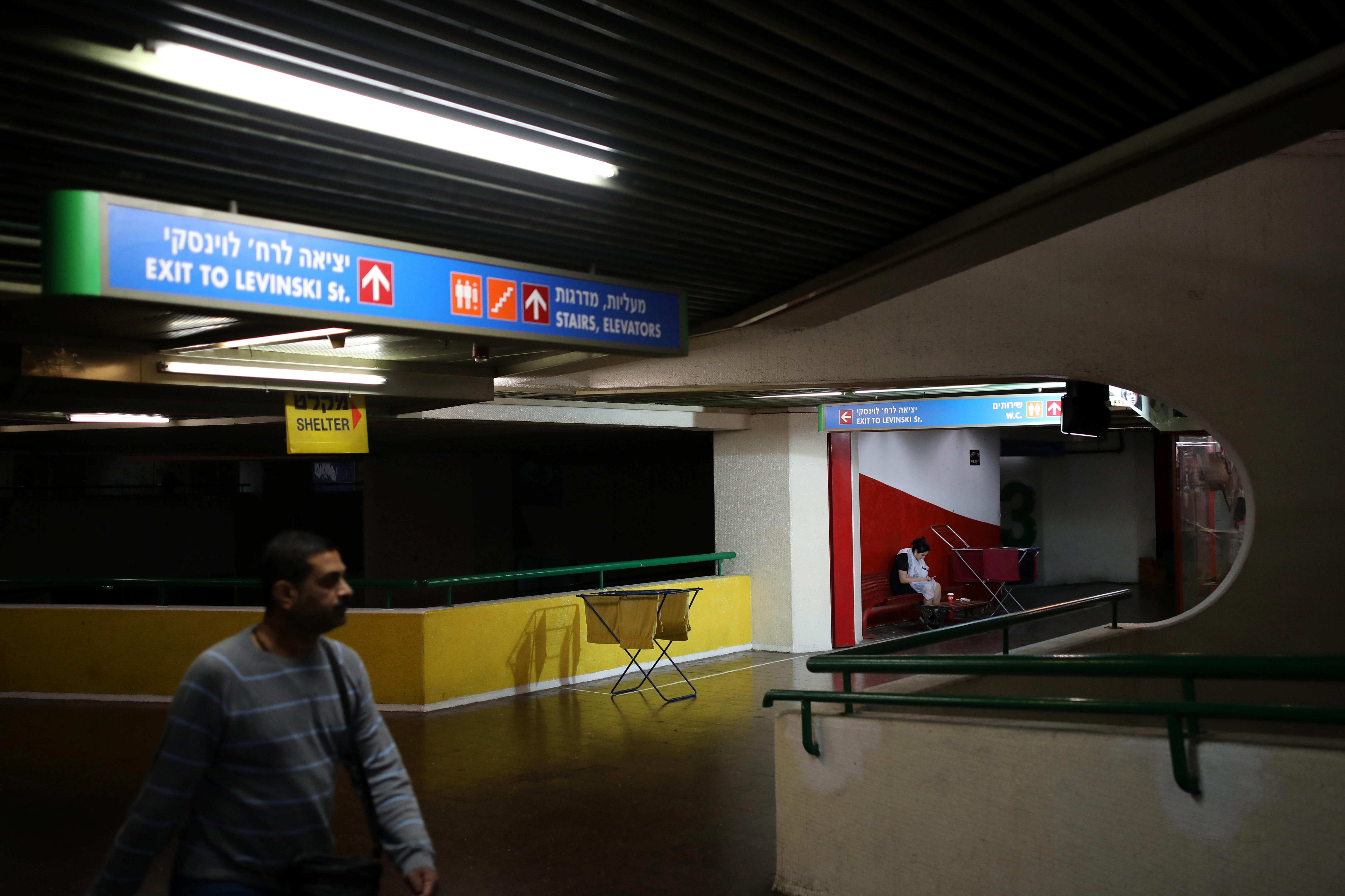 A man walks by as a woman waits outside a hairdresser shop at the Central Bus Station in Tel Aviv, Israel January 11, 2019. u00e2u20acu201d Reuters pic