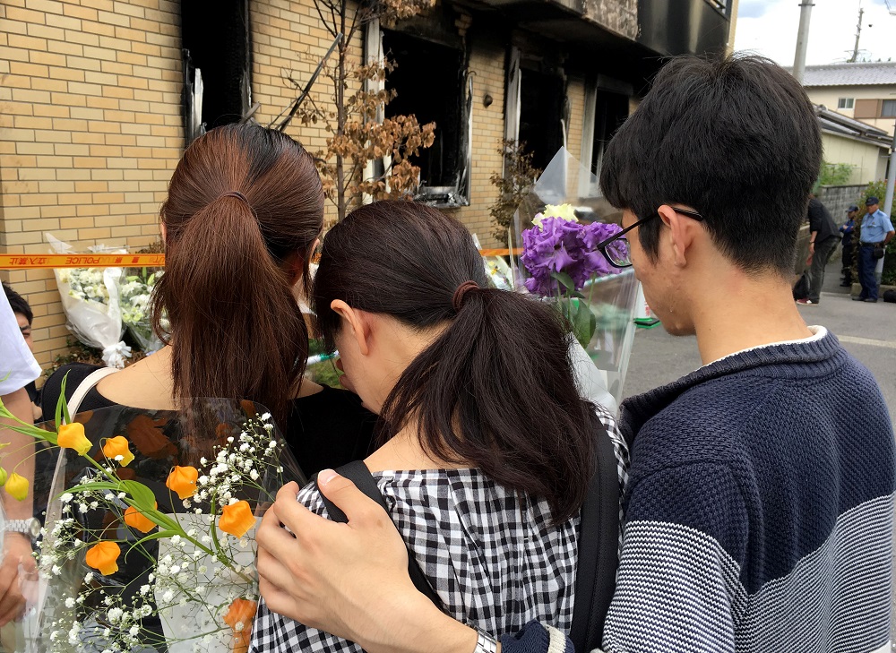 People react as they visit the Kyoto Animation building which was torched in an arson attack, in Kyoto, Japan July 21, 2019. u00e2u20acu201d Reuters pic