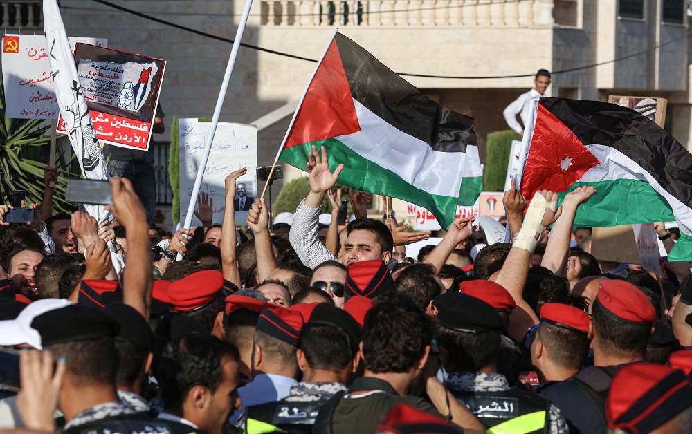 Protesters wave Palestinian (centre) and Jordanian flags during the u00e2u20acu02dcMarch of Angeru00e2u20acu2122 demonstration leading to the US embassy in the Jordanian capital Amman on June 21, 2019. u00e2u20acu201d AFP pic         