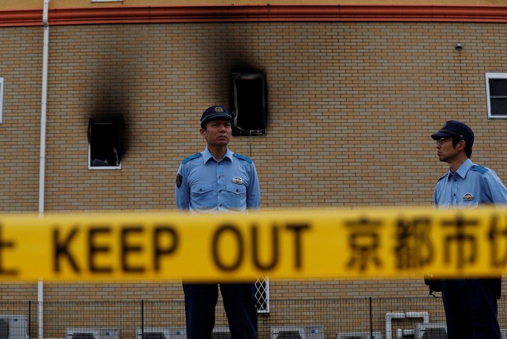 Policemen stand behind a police line at the torched Kyoto Animation building in Kyoto, Japan, July 20, 2019. u00e2u20acu201d Reuters pic