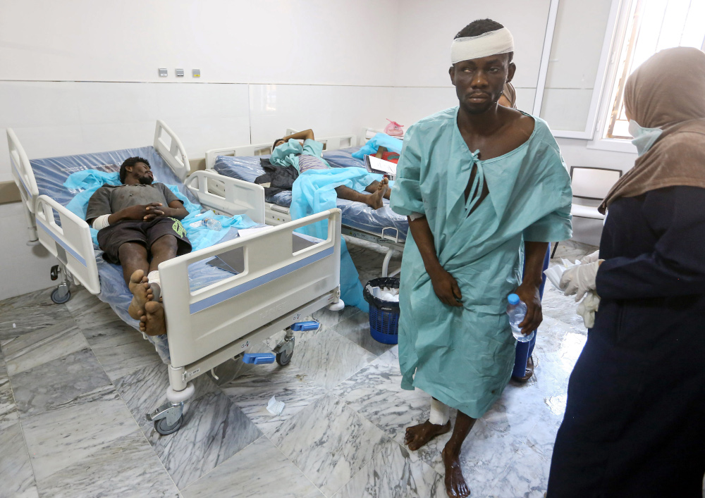 An injured migrant walks at a medical emergency ward in a hospital in the capital Tripoli July 3, 2019, following an air strike on a nearby building that left dozens killed the previous night. u00e2u20acu201d AFP pic 