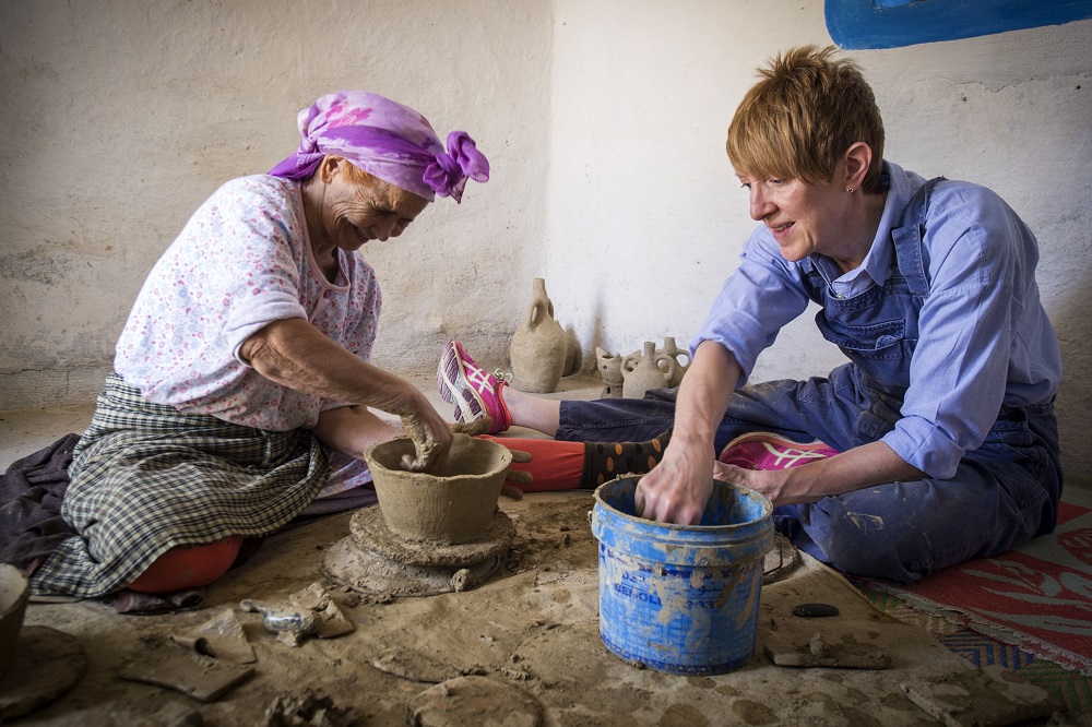 Moroccan potter Aicha Tabiz (left), also known as Mama Aicha, sits next to British apprentice Kim West, 33, during a pottery workshop near the village of Ourtzagh in the foothills of the Rif mountains June 12, 2019. — AFP pic         
