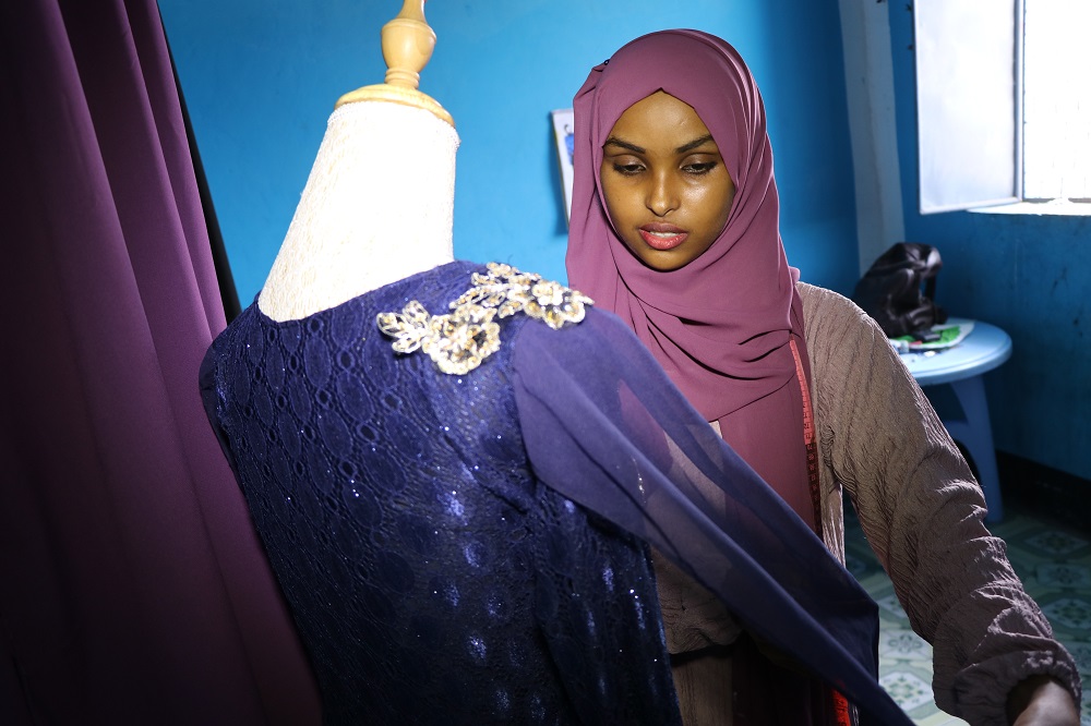Hawa Adan Hassan, a 23-year-old university student and a young Somali female fashion designer checks her new finished fashion design in Mogadishu November 3, 2018. u00e2u20acu201d AFP pic         