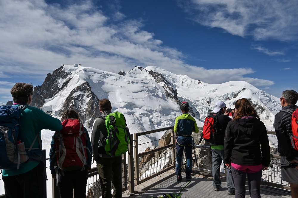 Tourists look at the Mont Blanc peak (centre) from the u00e2u20acu02dcAiguille du Midiu00e2u20acu2122 peak over the Chamonix valley, in the French Alps, eastern France July 20, 2019. u00e2u20acu201d AFP pic      