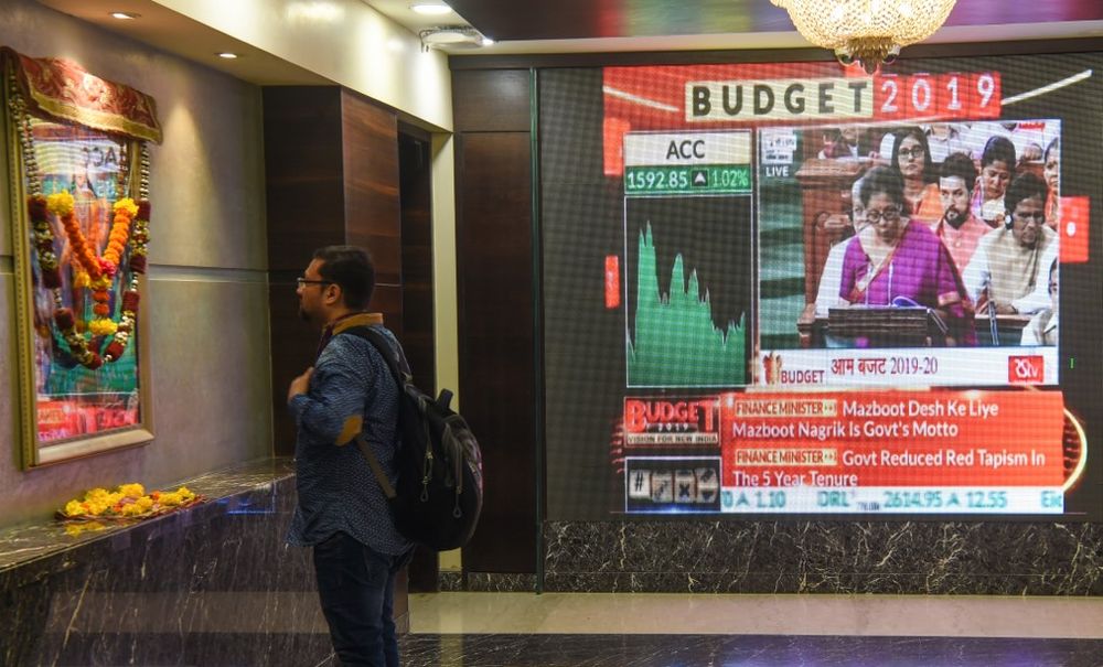 An Indian office worker prays in front of the Hindu goddess of wealth u00e2u20acu201c next to a broadcast of Indian Finance Minister Nirmala Sitharamanu00e2u20acu2122s budget speech, at the Bombay Stock Exchange (BSE) in Mumbai on July 5, 2019. u00e2u20acu201d AFP pic