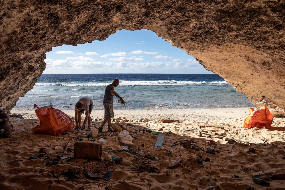 This handout photograph taken on June 16, 2019 and received on July 30 from New Zealand-based media group Stuff shows beach clean-up team members collecting rubbish from a beach on Henderson Island, an uninhabited member of the Pitcairn Islands archipelago in the South Pacific Ocean. — Iain McGregor/STUFF/AFP pic    