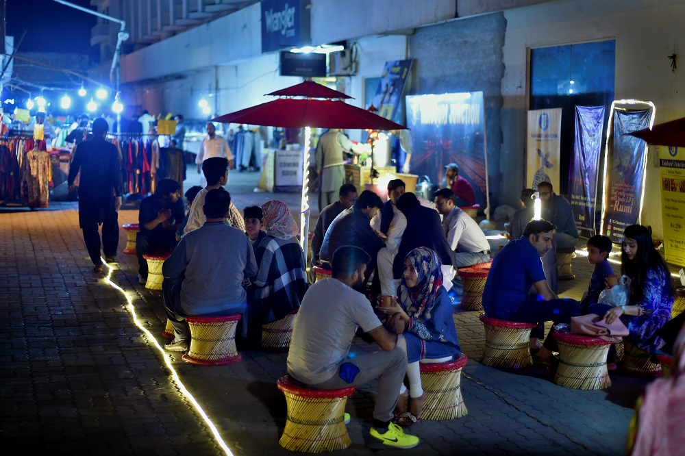 In this picture taken on March 29, 2019, Pakistani people gather to drink tandoori tea in clay pots at a market in Islamabad. — AFP pic