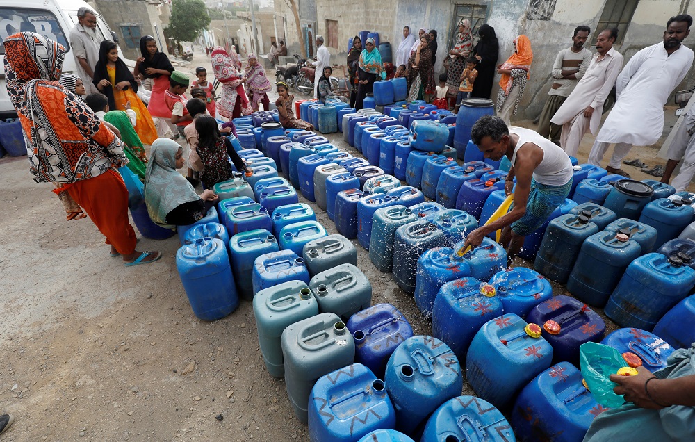 Residents gather to fill their empty containers at a free water distribution point in a low-income neighbourhood on the outskirts of Karachi, Pakistan June 28, 2019. u00e2u20acu201d Reuters pic