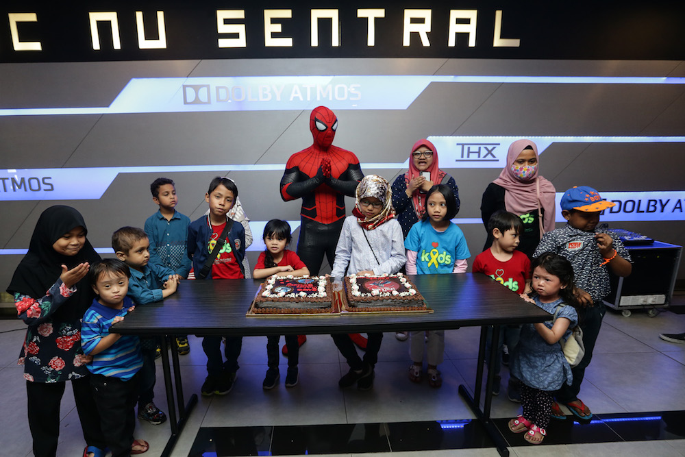 Children who were born in July celebrate their birthday with Spider-Man mascot after the movie screening. — Picture by Ahmad Zamzahuri