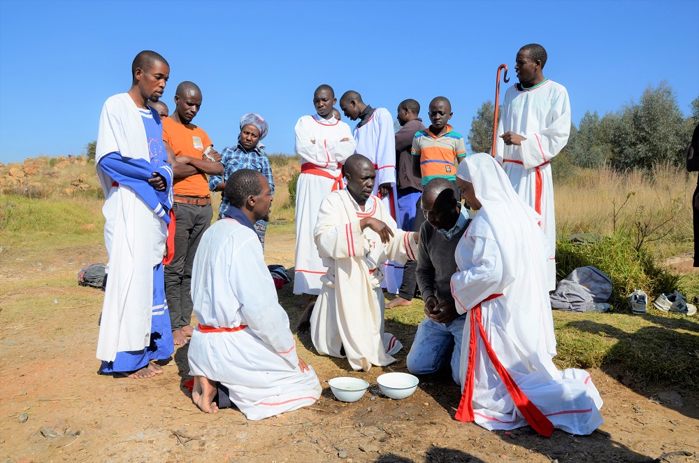 A church group gathers near the Flerhof Dam in Soweto, South Africa, blessing congregants with the water in bowls taken from the dam June 2, 2019. u00e2u20acu201d Thomson Reuters Foundation pic