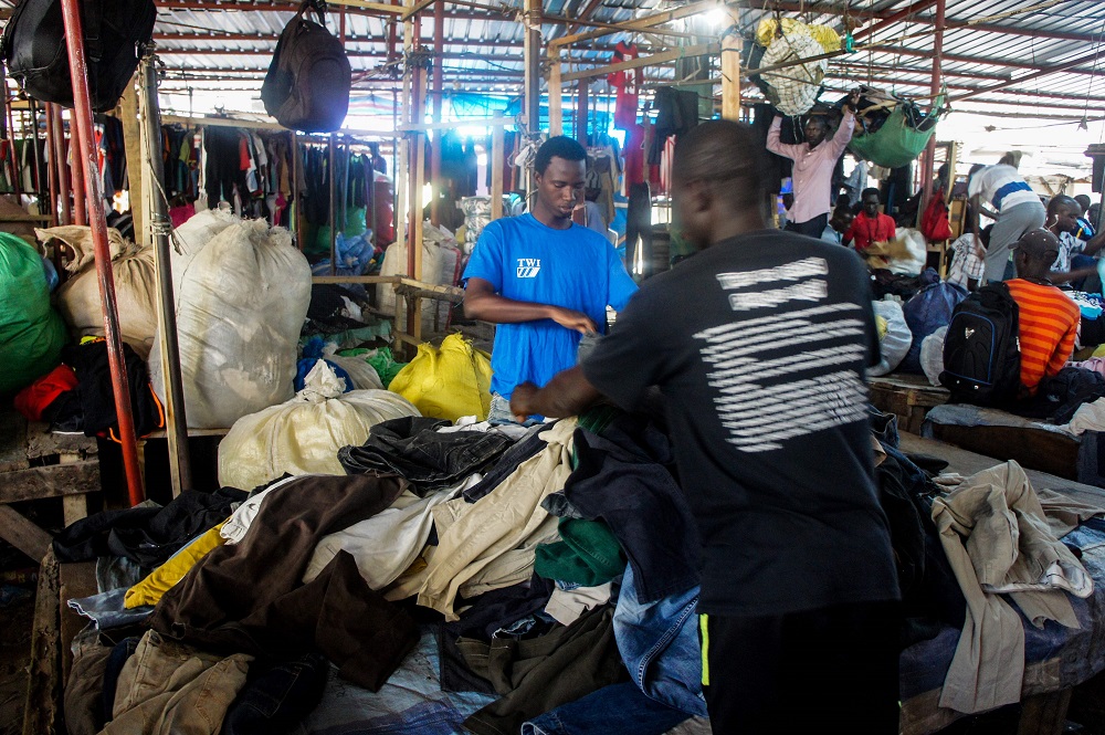 Mamadou Sarr (left), 23, a wholesaler of second-hand clothes prepares his stall at the Colobane Market, the biggest market of second-hand clothes in the Senegalese capital Dakar June 25, 2019. — AFP pic          
