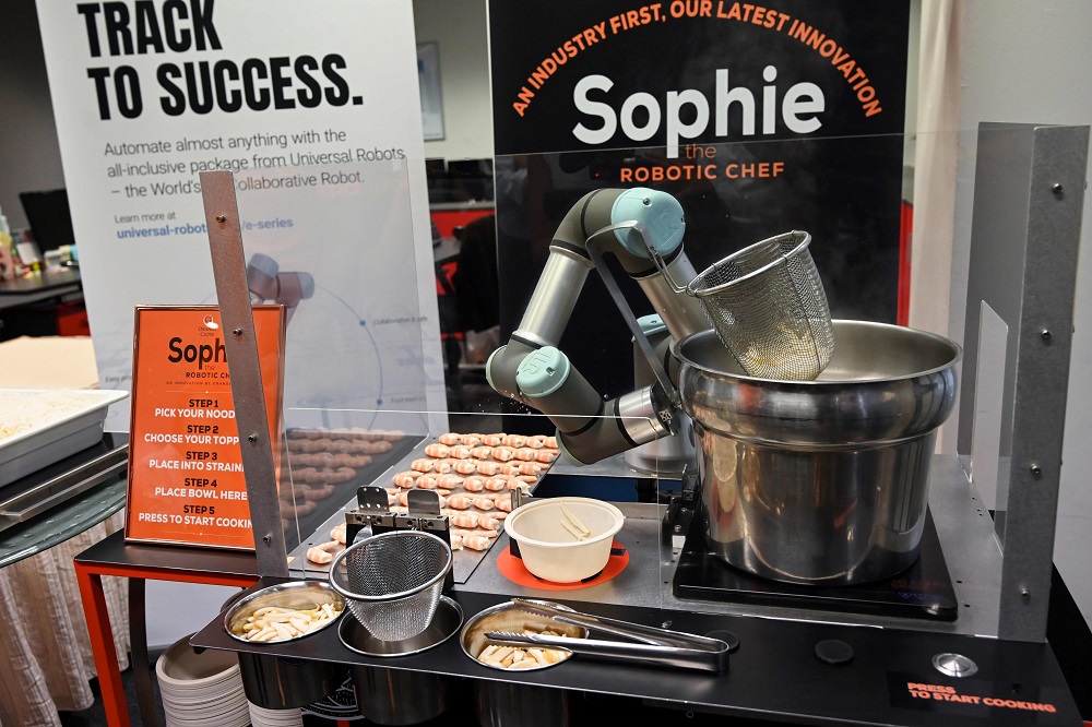 This picture taken on July 26, 2019 shows Sophie the robotic chef preparing to make laksa, a local dish of rice noodles served in a curry sauce, in Singapore. u00e2u20acu201d AFP pic 