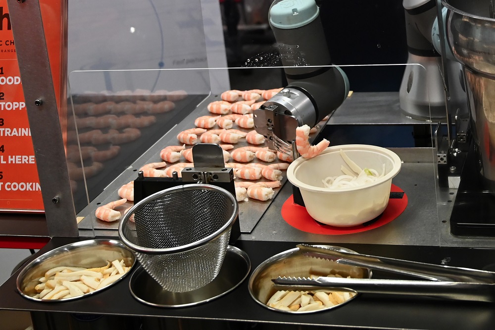 A robotic chef named Sophie prepares a bowl of laksa, a local dish of rice noodle in curry sauce during a demonstration in Singapore July 26, 2019. — AFP pic