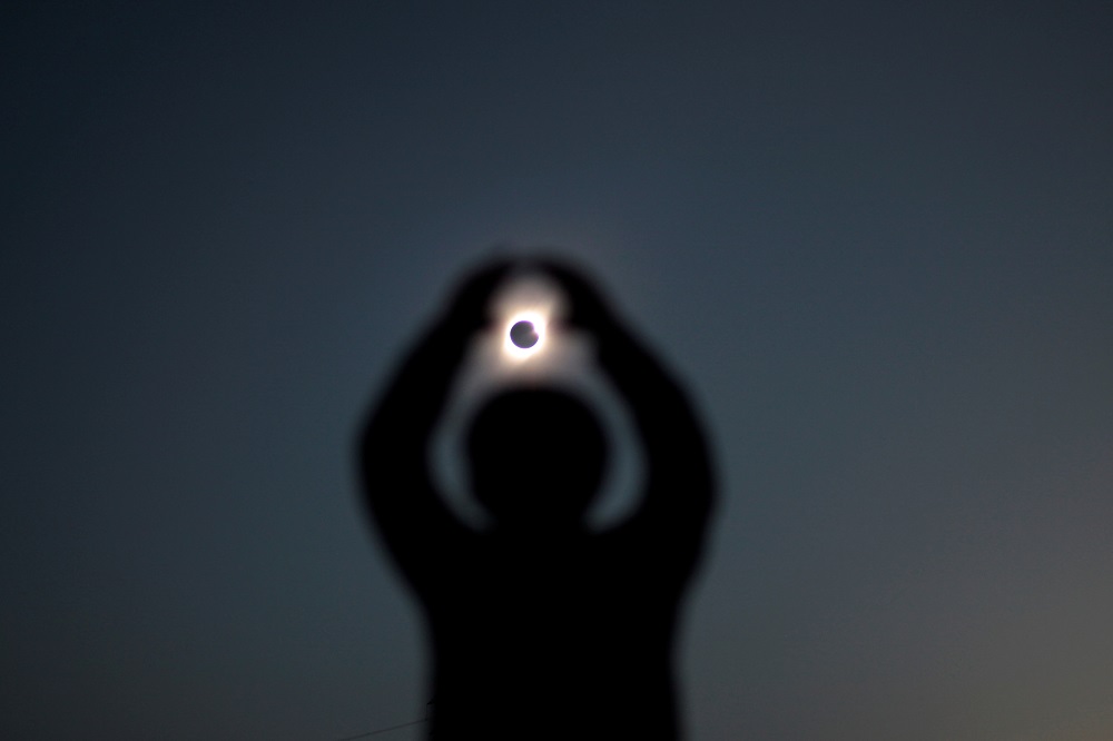 A person gestures while observing a solar eclipse at Incahuasi, Chile July 2, 2019. u00e2u20acu2022 Reuters pic