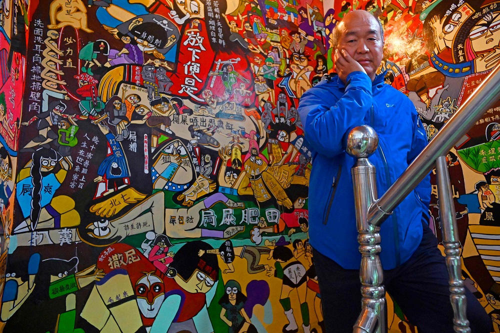 This picture taken on March 30, 2019 shows Hakka graffiti artist Wu Tsun-hsien posing for photos at his home in the Taiwanese village of Ruan Chiao. u00e2u20acu201d AFP pic        