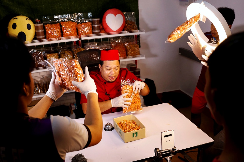 Anurak Sareuthai sells dried seafood products with his colleagues during a Facebook live event at his house in Satun province, southern Thailand May 30, 2019. u00e2u20acu201d Reuters pic