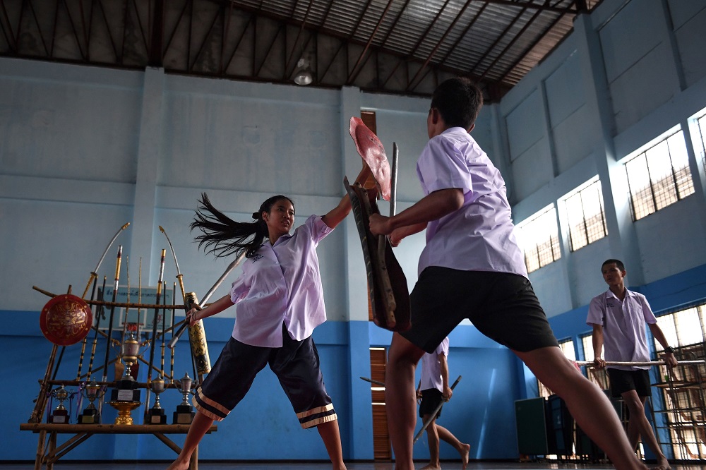 This photo taken on July 8, 2019 shows students practising Krabi Krabong, a Thai martial art, at the Thonburee Woratapeepalarak school in Thonburi, on the outskirts of Bangkok. — AFP pic