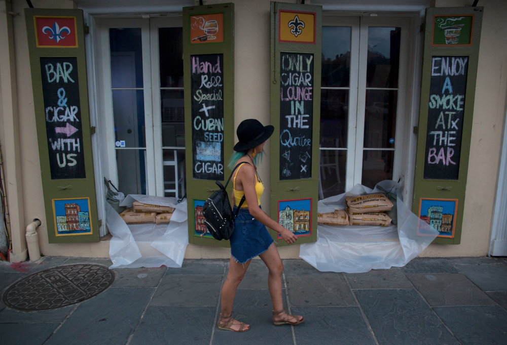 A woman walks past a cigar lounge and bar with sandbags lining in the French Quarter in preparation for tropical storm Barry in New Orleans, Louisiana, July 11, 2019. u00e2u20acu201d AFP pic 