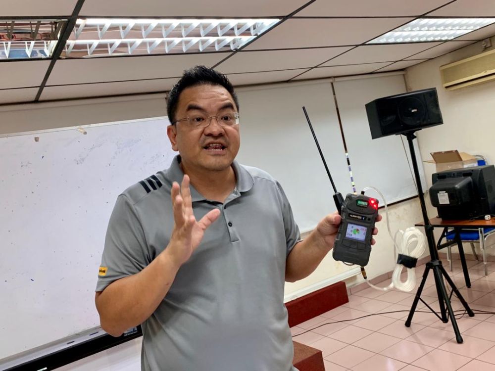 Tan demonstrates the limitations of the gas detector device. u00e2u20acu201d Picture by Ben Tan