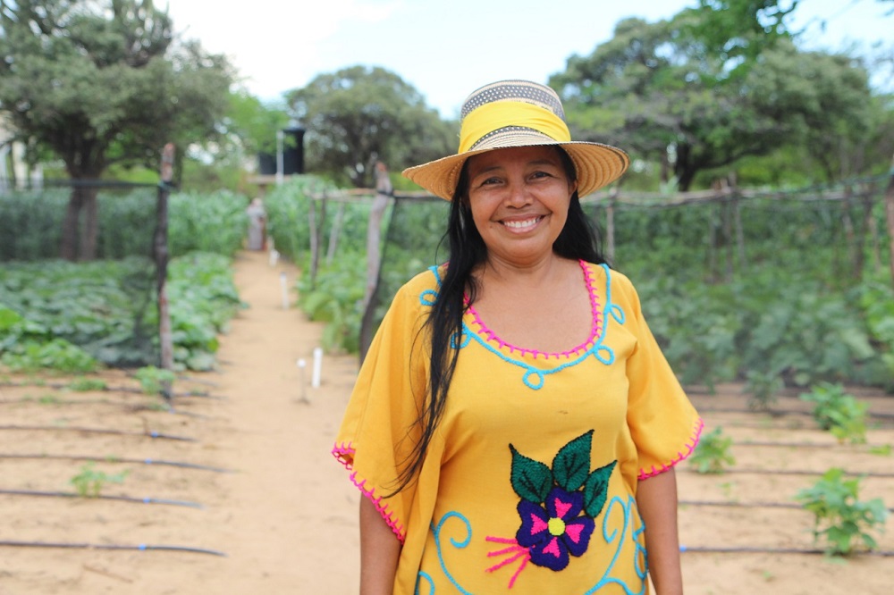Lucero Granadillo, 53, in front of the garden growing fruits, vegetables and cereals in the Tutchon community in the dry and arid La Guajira region in northeast Colombia on Jun 5, 2019. u00e2u20acu201d Thomson Reuters Foundation pic