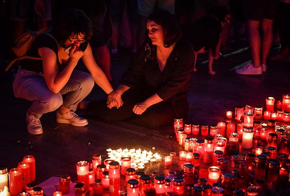 People light candles at a makeshift memorial site in front of the Romanian Ministry of Interior in Bucharest July 27, 2019 to commemorate Alexandra, the 15-year-old girl who was murdered. u00e2u20acu201d AFP pic