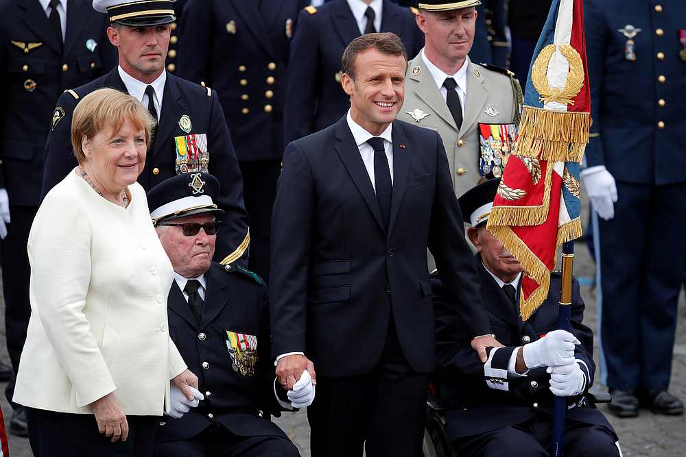 German Chancellor Angela Merkel and French President Emmanuel Macron attend the traditional Bastille Day military parade on the Champs-Elysees Avenue in Paris July 14, 2019. u00e2u20acu201d Reuters pic