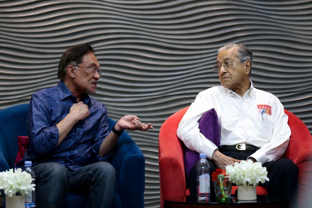 Datuk Seri Anwar Ibrahim speaks to Tun Dr Mahathir Mohamad during PKRu00e2u20acu2122s retreat at the Lexis Hibiscus resort in Port Dickson July 19, 2019. u00e2u20acu201d Picture by Ahmad Zamzahuri
