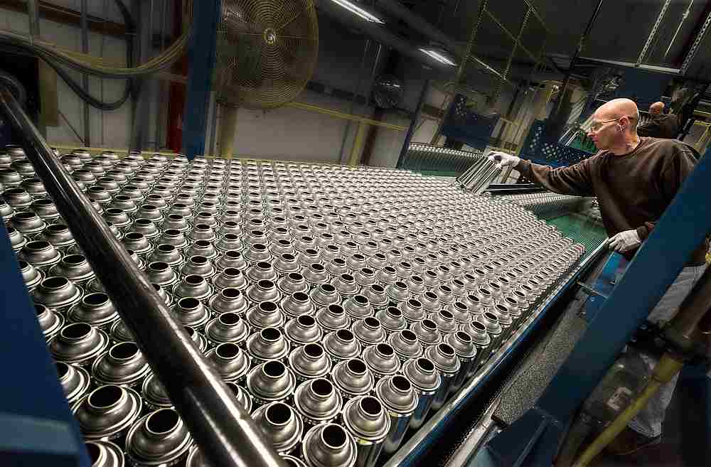 A worker at Ball Metalpack's plant checks aerosol cans made with tinplate steel in Horsham, Pennsylvania June 12, 2019. u00e2u20acu201d Ball Metalpack handout via Reuters