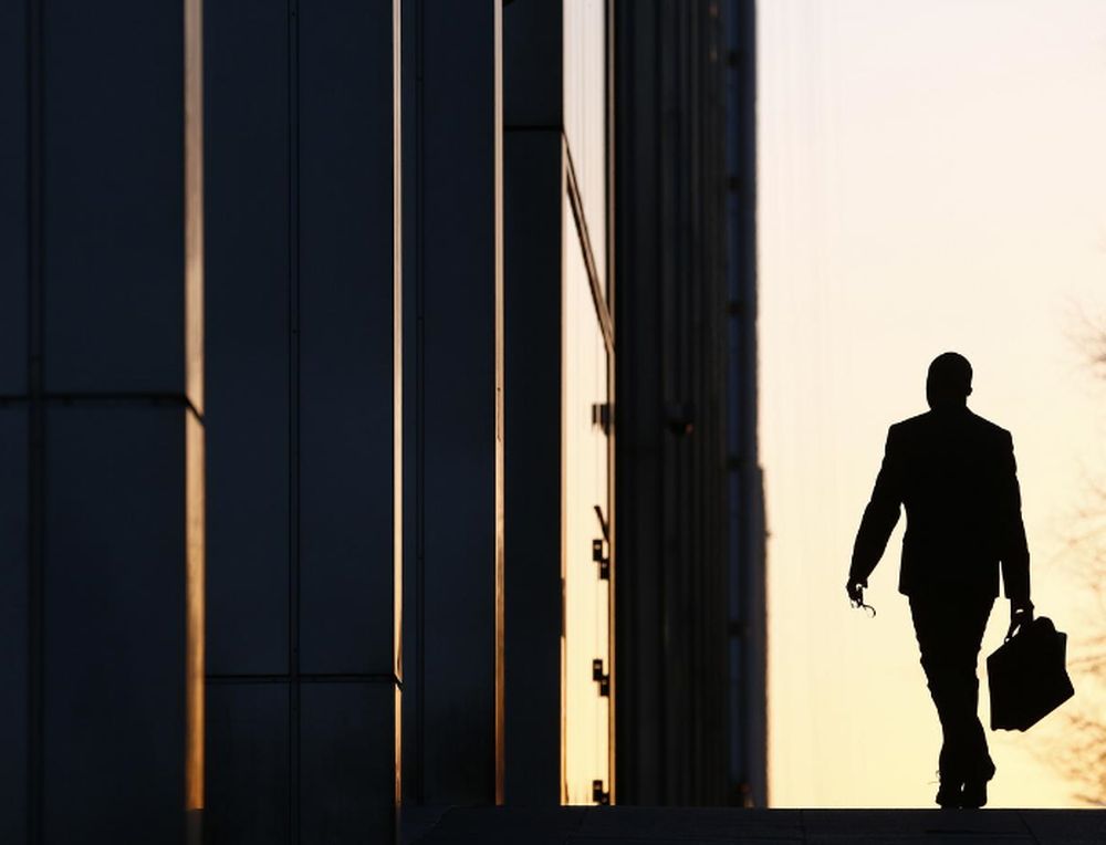 A worker arrives at his office in the Canary Wharf business district in London February 26, 2014. u00e2u20acu201d Reuters pic
