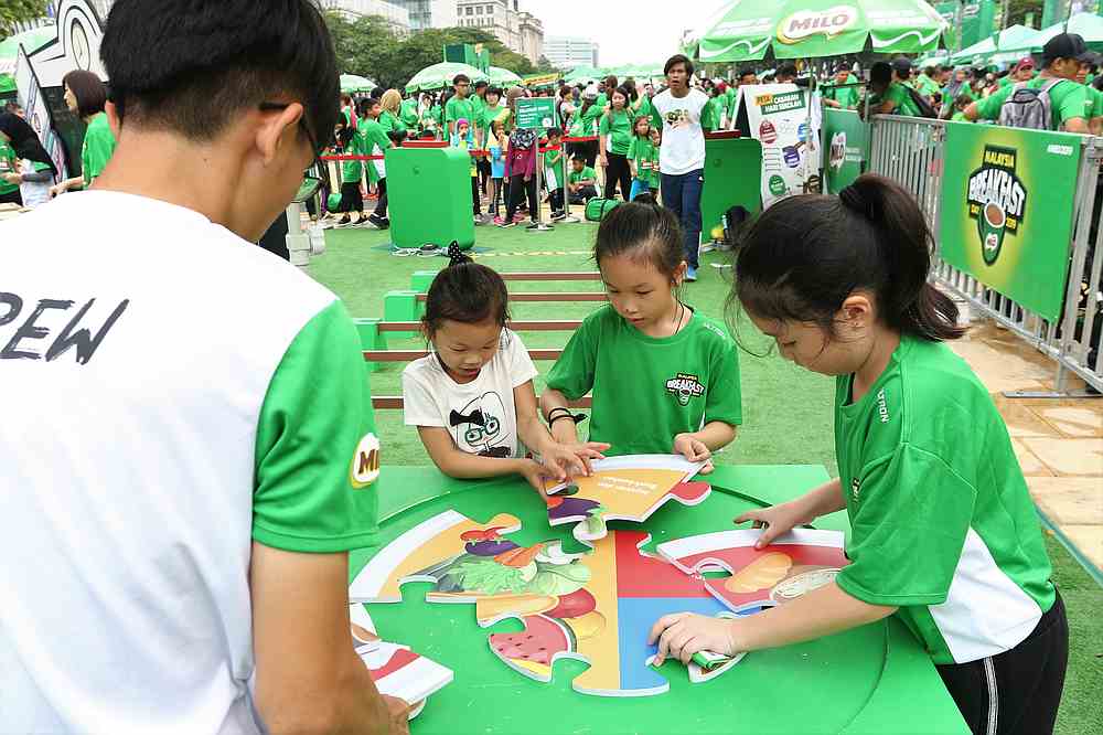 Children learning about the Malaysian healthy plate model during the event. — Picture courtesy of Nestle Bhd