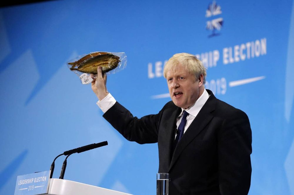 Boris Johnson holds up kipper fish in plastic packaging as he blasts EU food rules. u00e2u20acu201d AFP pic