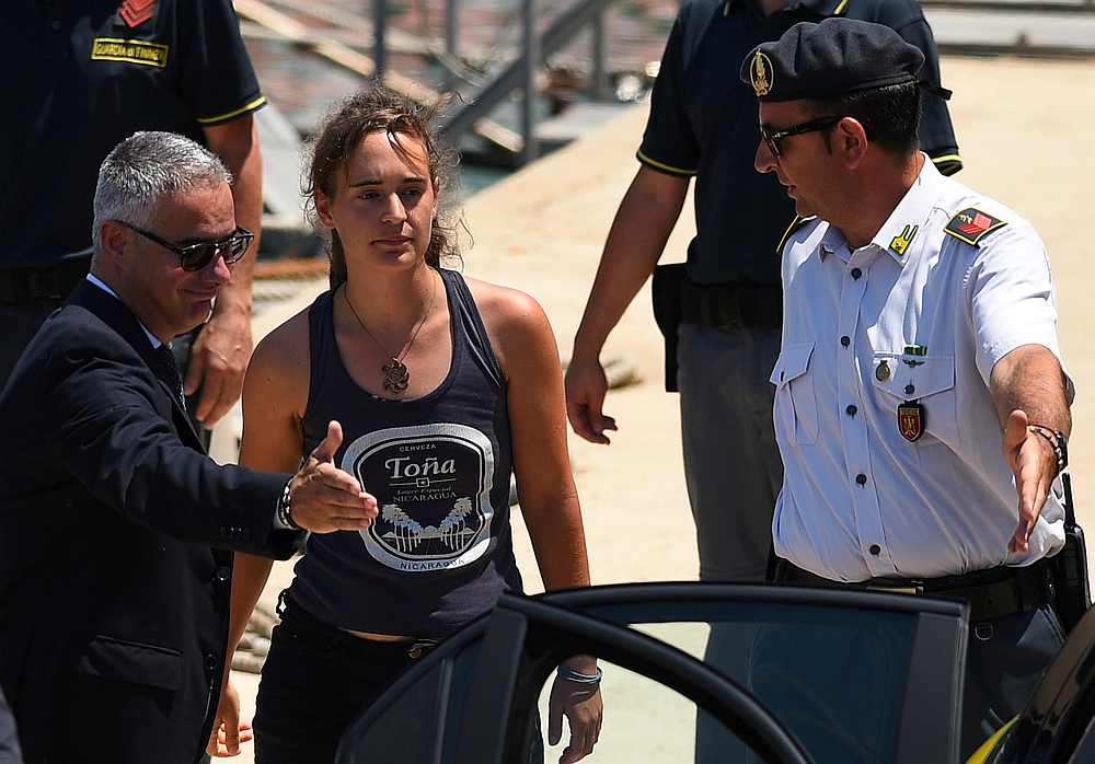 Carola Rackete, the 31-year-old Sea-Watch 3 captain, disembarks from a Finance police boat and is escorted to a car, in Porto Empedocle, Italy July 1, 2019. u00e2u20acu201d Reuters pic