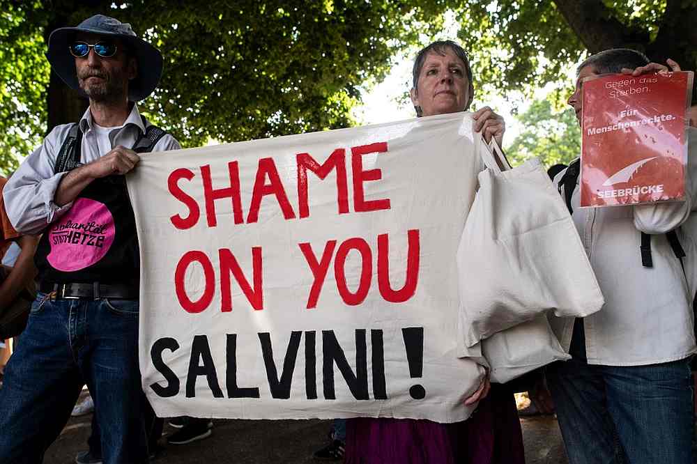 Demonstrators hold a banner reading 'Shame on you Salvini!' during a vigil on July 2, 2019 in Cologne, western Germany, for Carola Rackete, German captain of a rescue charity ship. u00e2u20acu201d AFP pic