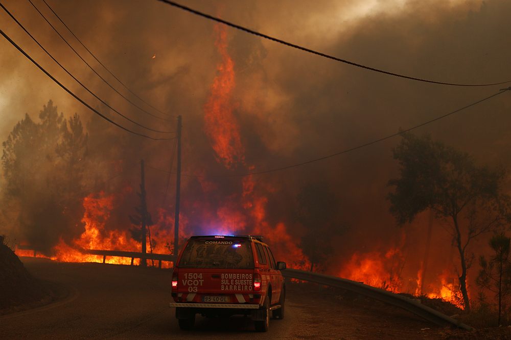 Firefighters drive through smoke from a forest fire in Chaveira, Portugal July 22, 2019. u00e2u20acu201d Reuters pic