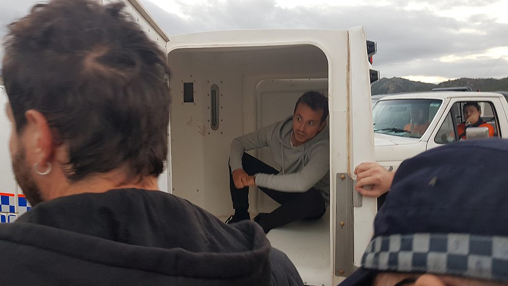 French TV reporter Hugo Clement is seen in a police van after he was arrested while filming protesters blockading the Abbot Point coal port near Bowen, Queensland, Australia July 22, 2019. u00e2u20acu201d Frontline Action on Coal handout via Reuters