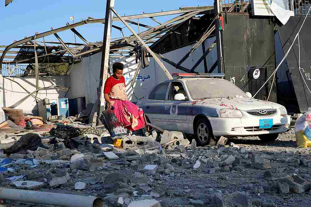 A migrant picks up clothes from among rubble at a detention centre for mainly African migrants that was hit by an air strike in the Tajoura suburb of Tripoli July 3, 2019. u00e2u20acu201d Reuters pic