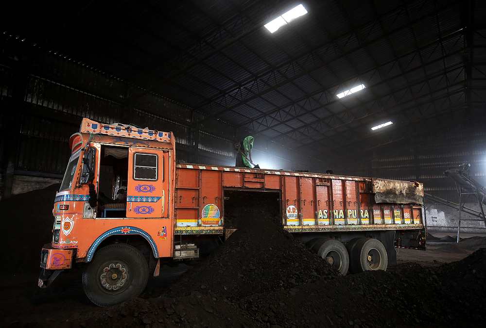 A worker shovels coal in a supply truck at a yard on the outskirts of Ahmedabad, India October 25, 2018. u00e2u20acu201d Reuters pic