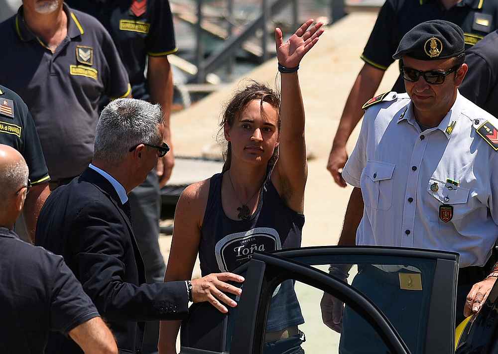 Carola Rackete, the 31-year-old Sea-Watch 3 captain, disembarks from a Finance police boat and is escorted to a car, in Porto Empedocle, Italy July 1, 2019. u00e2u20acu201d Reuters pic 